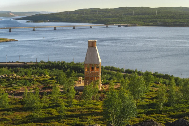 Kola Bay Lighthouse Viewpoint by Timber Architecture Workshop, wide view over the bay, bridge, and hillside vegetation
