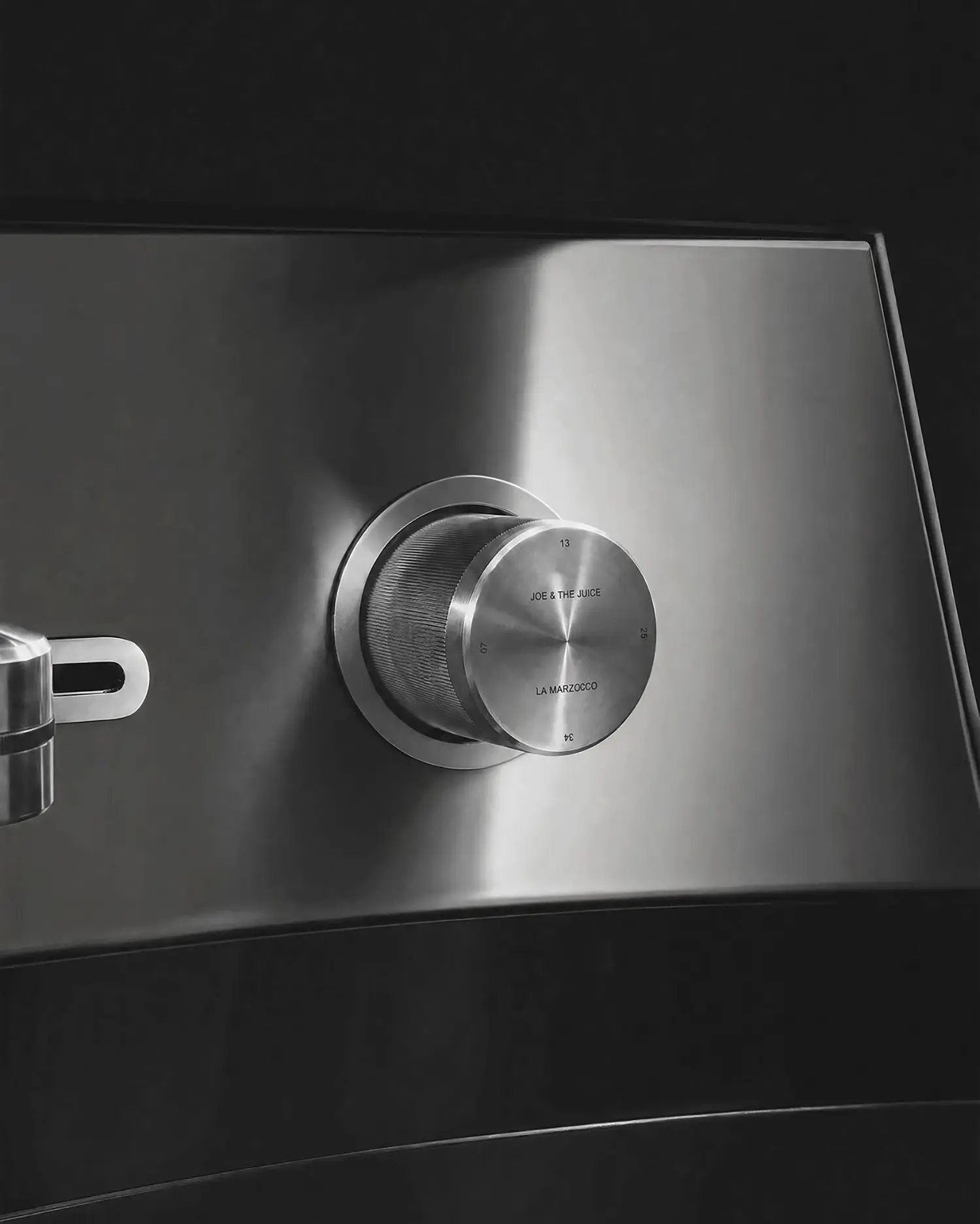 La Marzocco Linea Mini by CALIPER, macro detail of Joe & The Juice and La Marzocco engraved knob, numbers 07, 25, 34