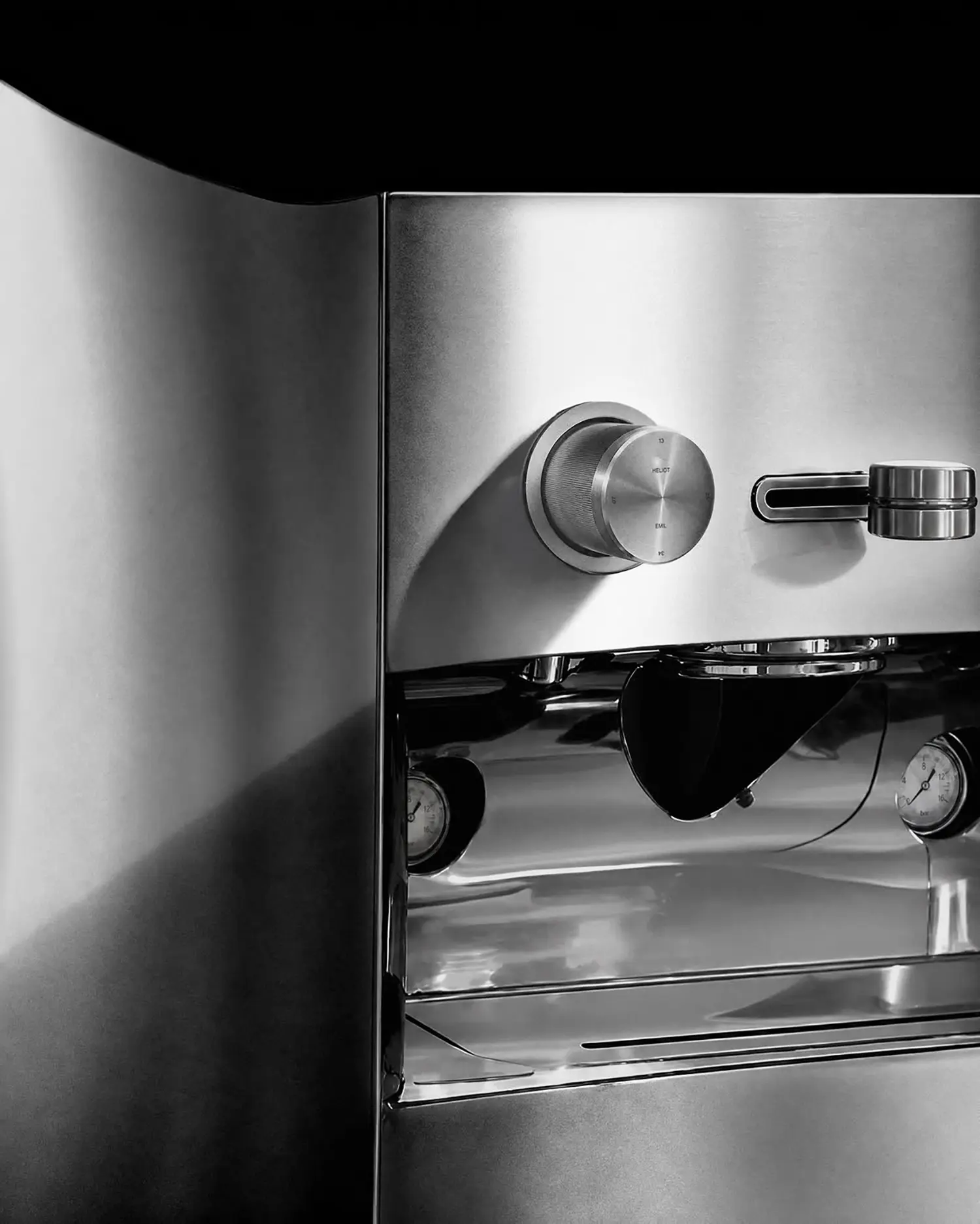 La Marzocco Linea Mini by CALIPER, close-up of curved housing seam, Heliot Emil knob and portafilter lever, twin gauges and drainage tray below