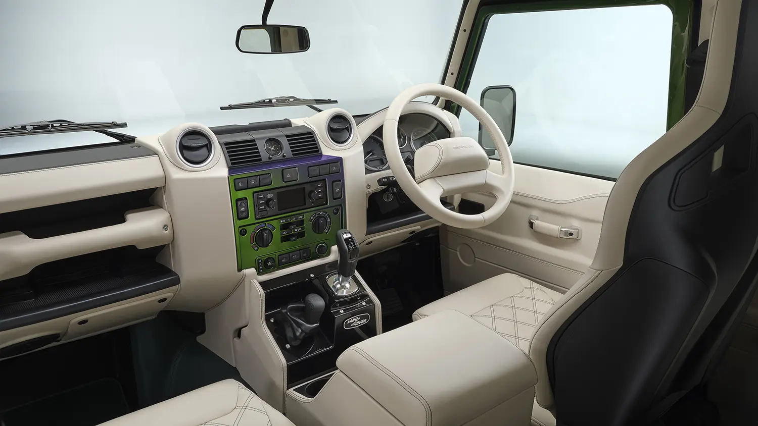 Land Rover Classic Defender V8 interior, Vanilla leather dashboard and steering wheel, Spectral Green centre fascia panel