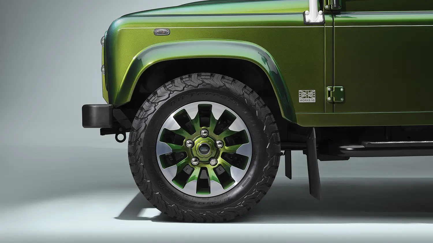 Detail of Land Rover Classic Defender V8 wheel arch and Sawtooth alloy wheel, Spectral Green paint, Works V8 badge