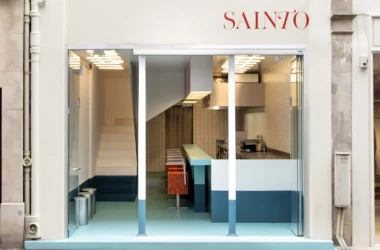 Sainto restaurant by Mur Mur, Paris — storefront view with teal-to-light floor gradient, staircase, and kitchen counter