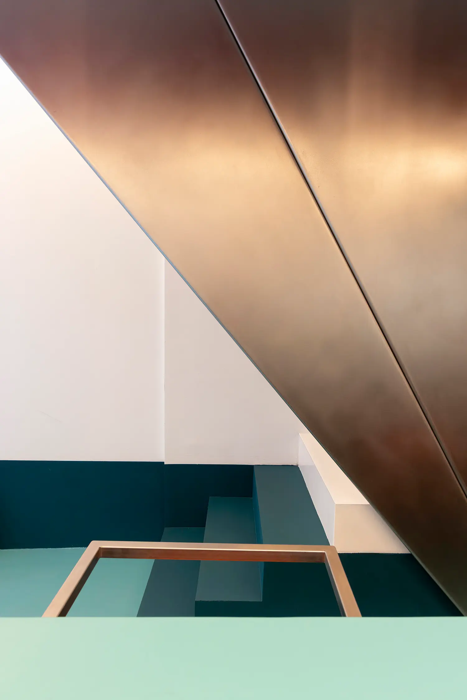 Sainto by Mur Mur, abstract detail of angled steel railing against teal stair risers