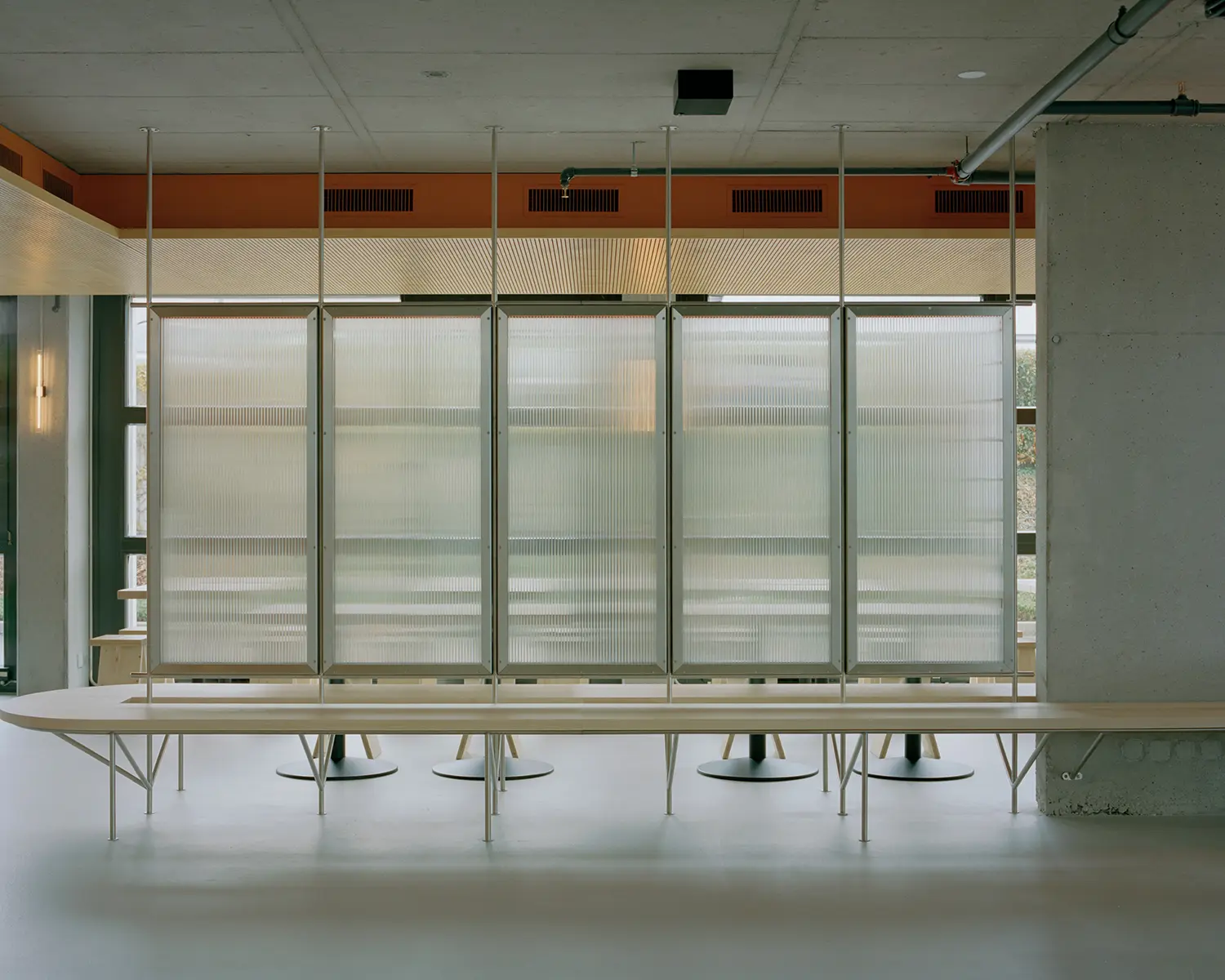 Eleventhfloor Restaurant by Noue Studio, full view of suspended polycarbonate panel wall dividing dining area