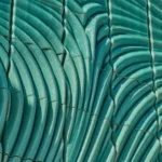 Detail of Powerwall by Studio RAP showing ribbed 3D-printed ceramic tiles in translucent turquoise glaze with radiating relief pattern