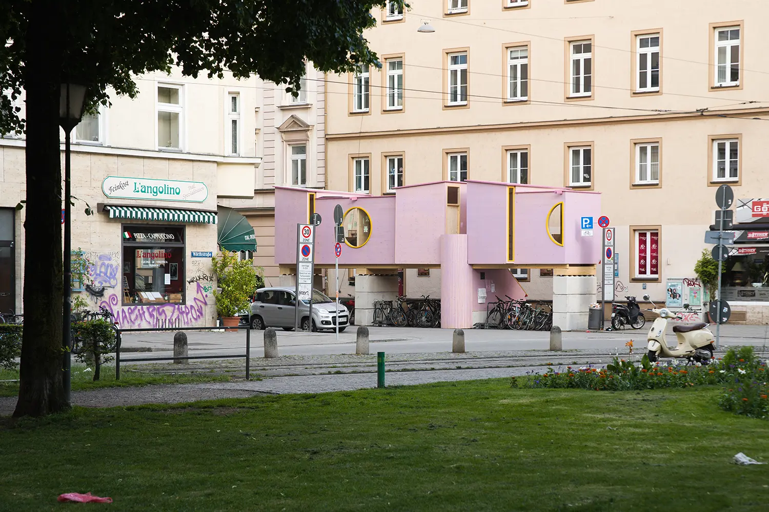 ZuHaus by Clemens Hoyer, pink timber volume raised over a Munich sidewalk between two apartment buildings