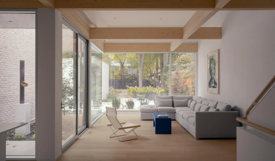 Living space of Casa Loma Residence by StudioAC, spanned by exposed glulam beams with the sculpture court visible to the left | Photo Felix Michaud