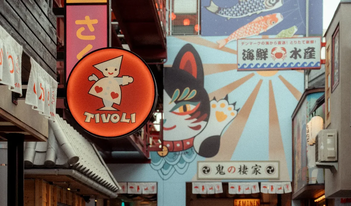 Hikari at Tivoli Gardens, Copenhagen, illuminated signage with maneki-neko mural and Tivoli logo. Photo: Anne-Sophie Rosenvinge