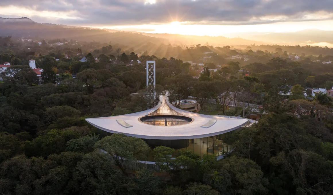 Aerial view of the Lola Mora Cultural Center by Pelli Clarke & Partners, its curving roof set in Yunga forest above San Salvador de Jujuy | Photo Jason O'Rear