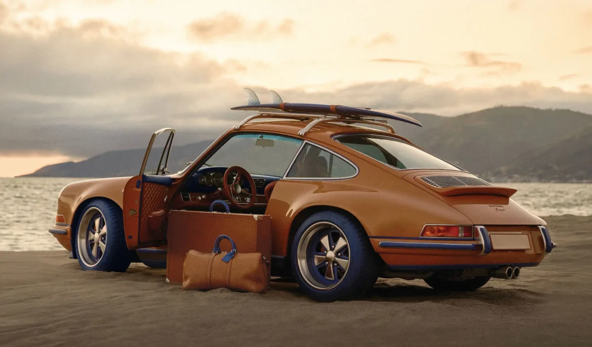 Porsche 911 Reimagined by Singer — Classic in saffron and cobalt blue, roof rack with Louis Vuitton surfboard and luggage — Photo: Singer Vehicle Design