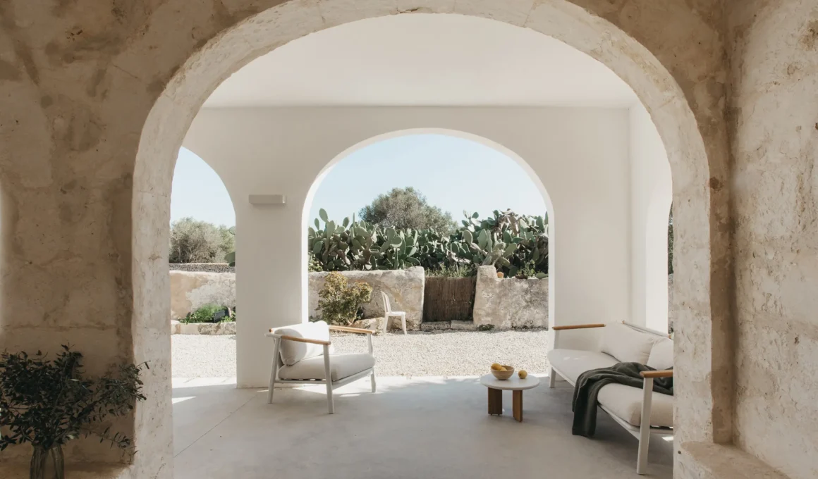 Son Martorell by idearch studio: marès stone archway framing a covered terrace, Menorca. Photo: María Missaglia