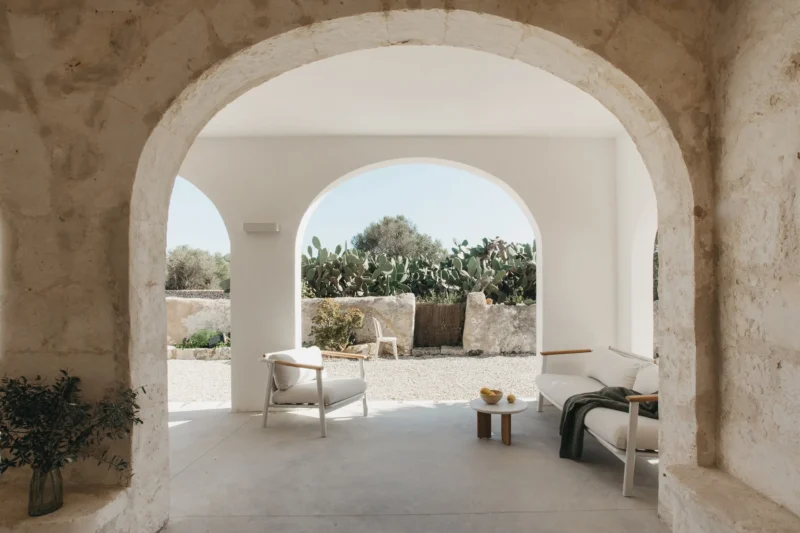 Son Martorell by idearch studio: marès stone archway framing a covered terrace, Menorca. Photo: María Missaglia