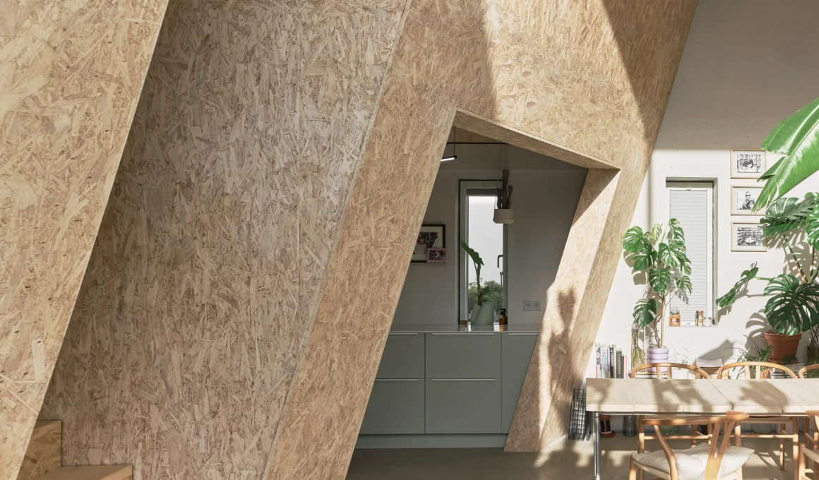 The Town House by Sigurd Larsen in Niedersprockhövel, tilted timber wall framing the kitchen threshold
