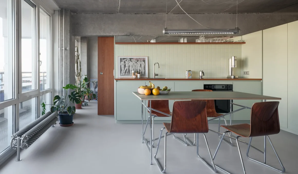 OASIS apartment by WERCK Workshop kitchen with sage cabinetry and tiled backsplash, photo by Till Schuster