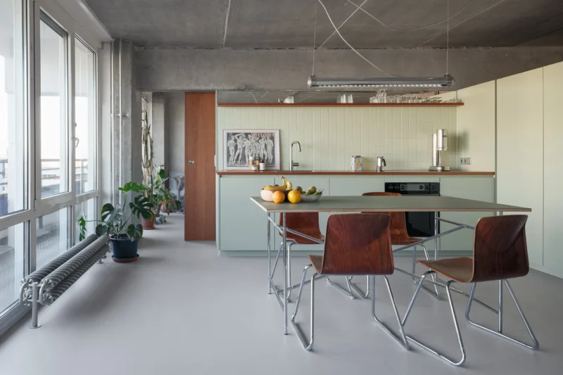 OASIS apartment by WERCK Workshop kitchen with sage cabinetry and tiled backsplash, photo by Till Schuster
