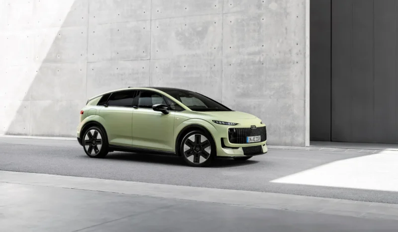 Audi A2 e-tron in pale green, three-quarter front view against a concrete wall