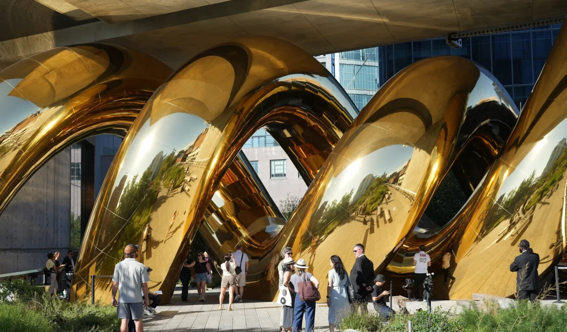 auruBOROS by Plastique Fantastique: golden mirrored TPU coils beneath The Standard's concrete underside, visitors on the High Line walkway