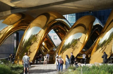 auruBOROS by Plastique Fantastique: golden mirrored TPU coils beneath The Standard's concrete underside, visitors on the High Line walkway