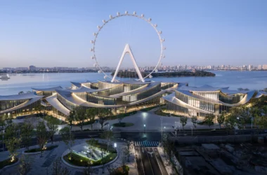 Suzhou Museum of Contemporary Art by BIG at dusk, undulating roof pavilions beside the Suzhou Ferris wheel and Jinji Lake