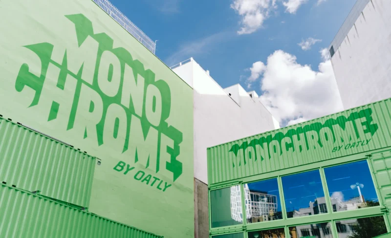 Monochrome by Oatly pop-up by Cee Cee Creative, green shipping containers with painted lettering in Berlin. Photo: Aditya Christian, Mohit Amlani