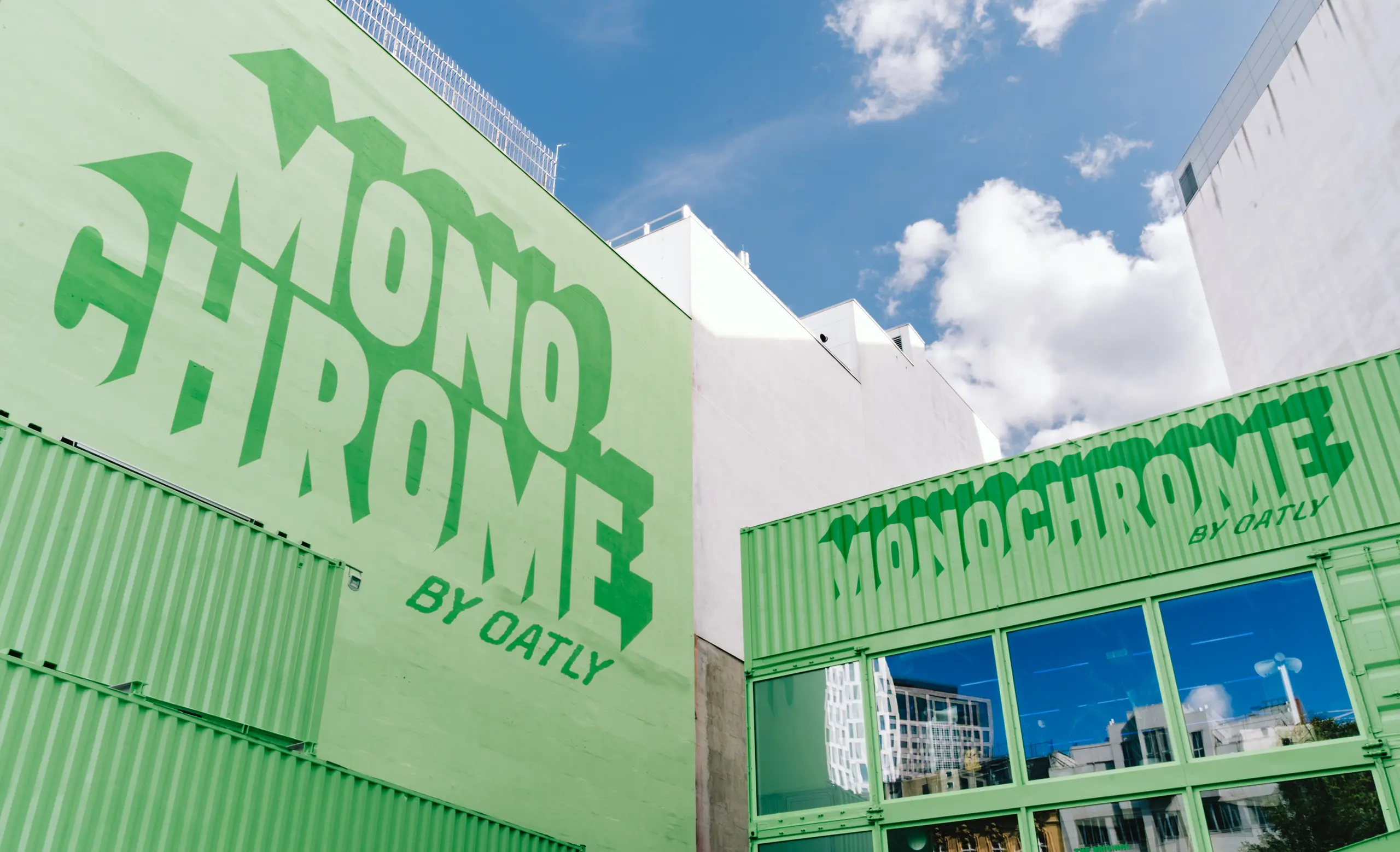 Monochrome by Oatly pop-up by Cee Cee Creative, green shipping containers with painted lettering in Berlin. Photo: Aditya Christian, Mohit Amlani