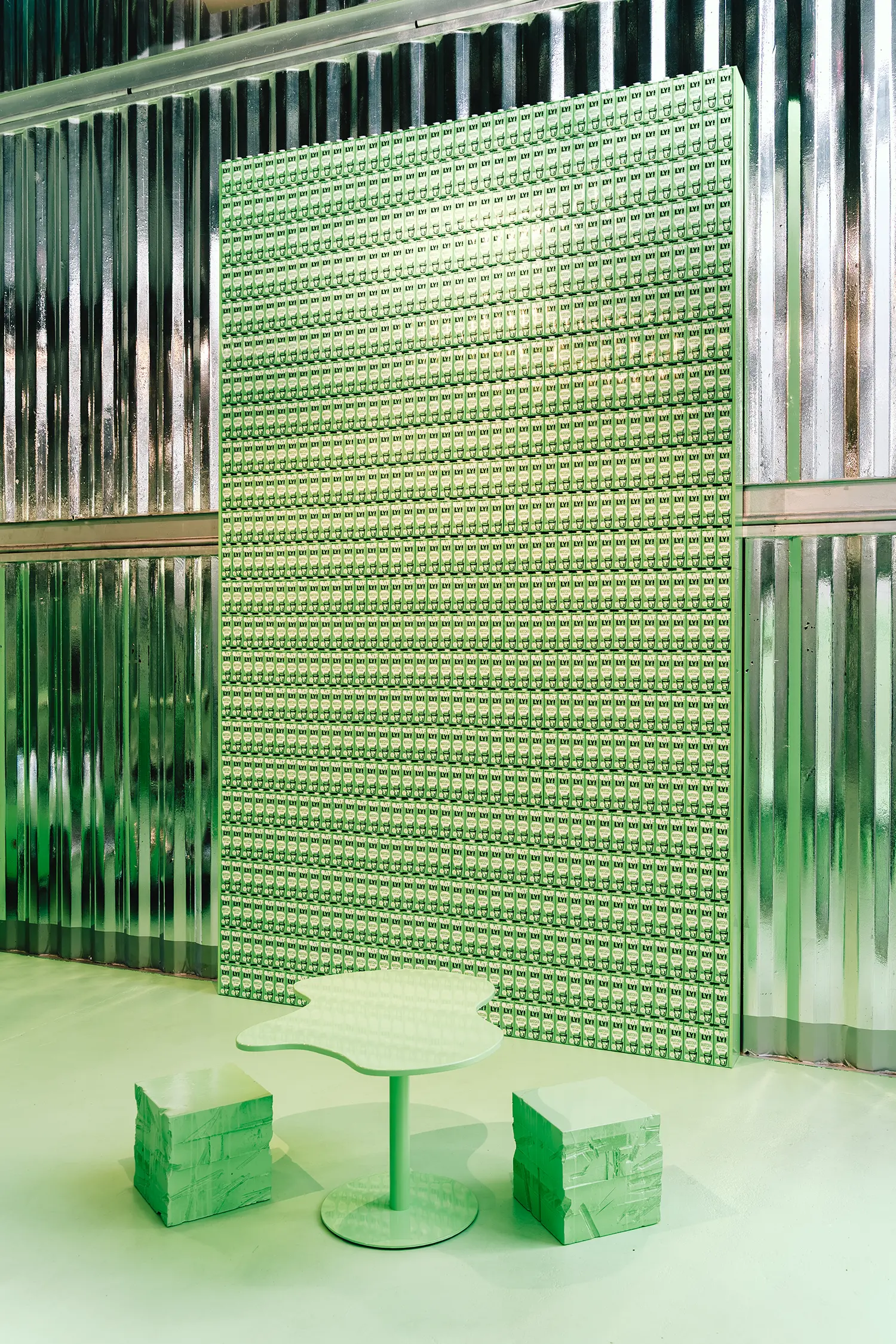 Wall of Oatly Matcha cartons, blob table and cube stools at Monochrome by Oatly by Cee Cee Creative. Photo: Aditya Christian, Mohit Amlani
