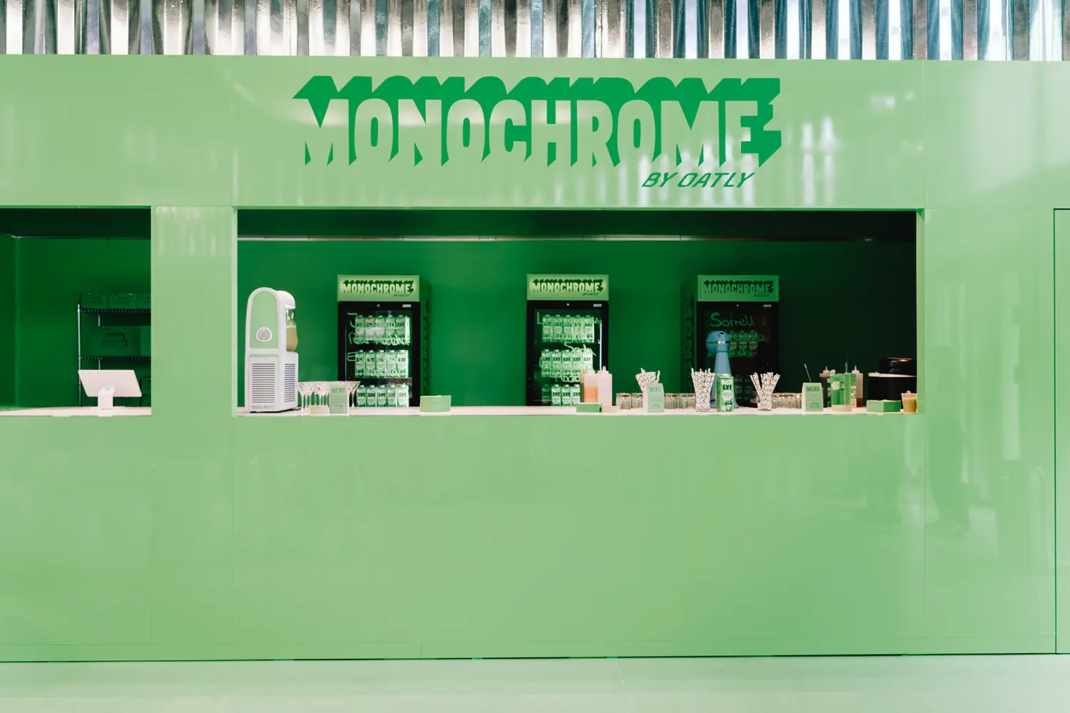 Green drinks counter with branded fridges at Monochrome by Oatly by Cee Cee Creative. Photo: Aditya Christian, Mohit Amlani