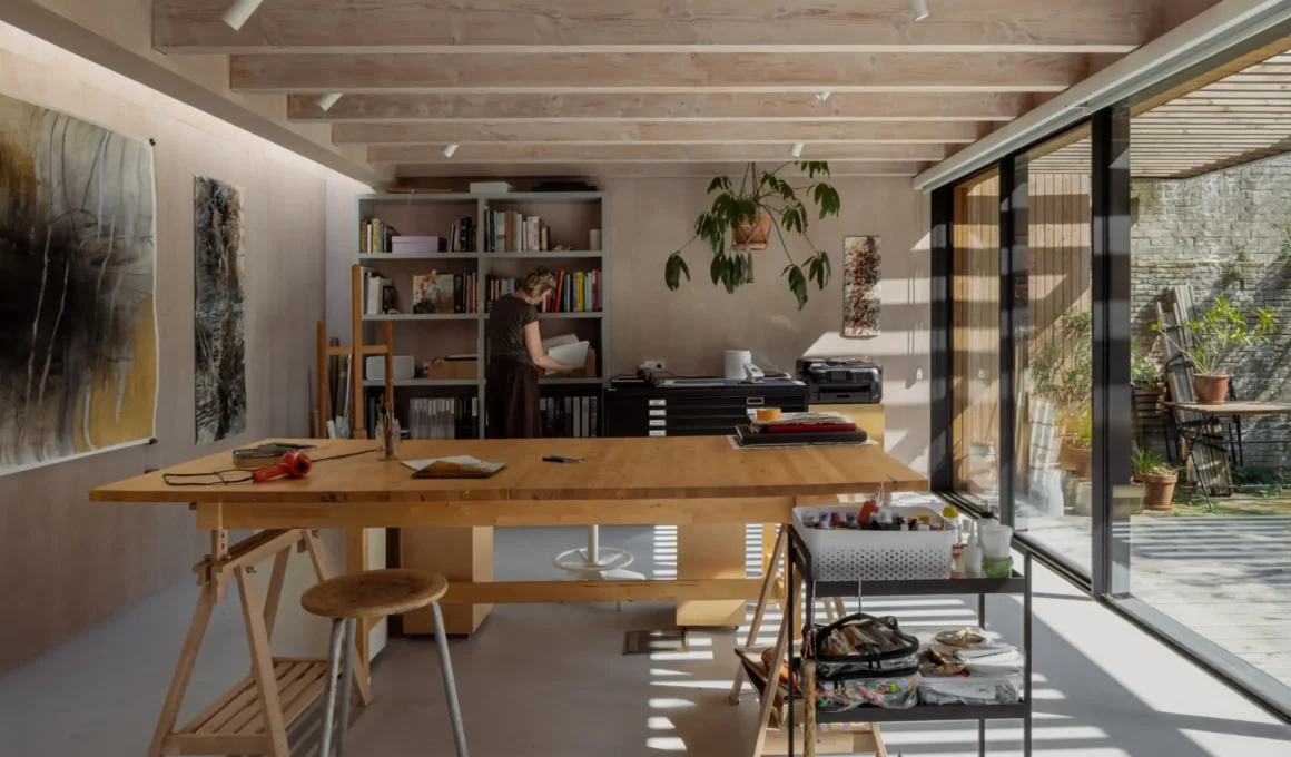 Painter's studio interior for DP6 architectuurstudio's Rear House project in Delft, with oak worktable and glazed garden wall