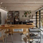 Painter's studio interior for DP6 architectuurstudio's Rear House project in Delft, with oak worktable and glazed garden wall