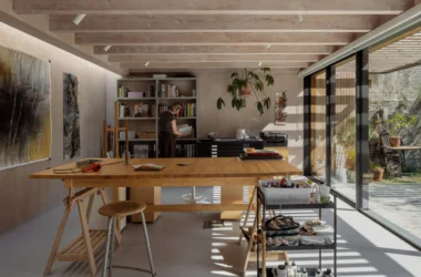 Painter's studio interior for DP6 architectuurstudio's Rear House project in Delft, with oak worktable and glazed garden wall