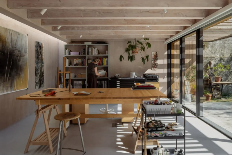 Painter's studio interior for DP6 architectuurstudio's Rear House project in Delft, with oak worktable and glazed garden wall