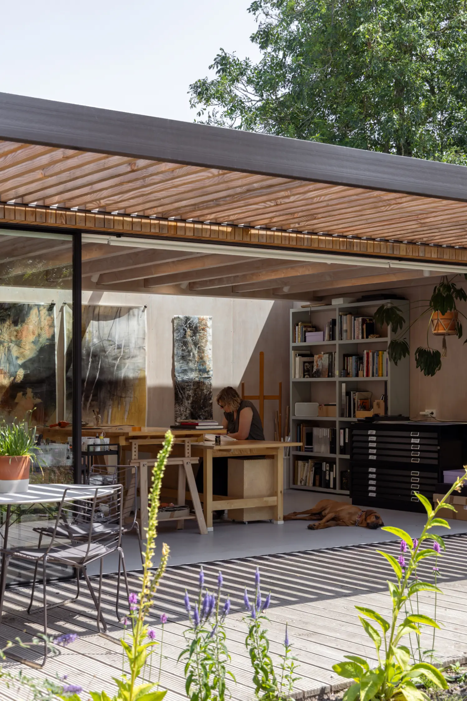 Garden view of DP6 architectuurstudio's Douglas fir painter's studio, Rear House project, Delft, seen beneath the wooden canopy