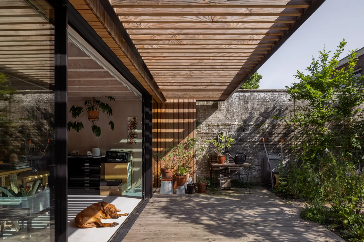 Threshold of the painter's studio opening onto the garden, DP6 architectuurstudio's Rear House project, Delft
