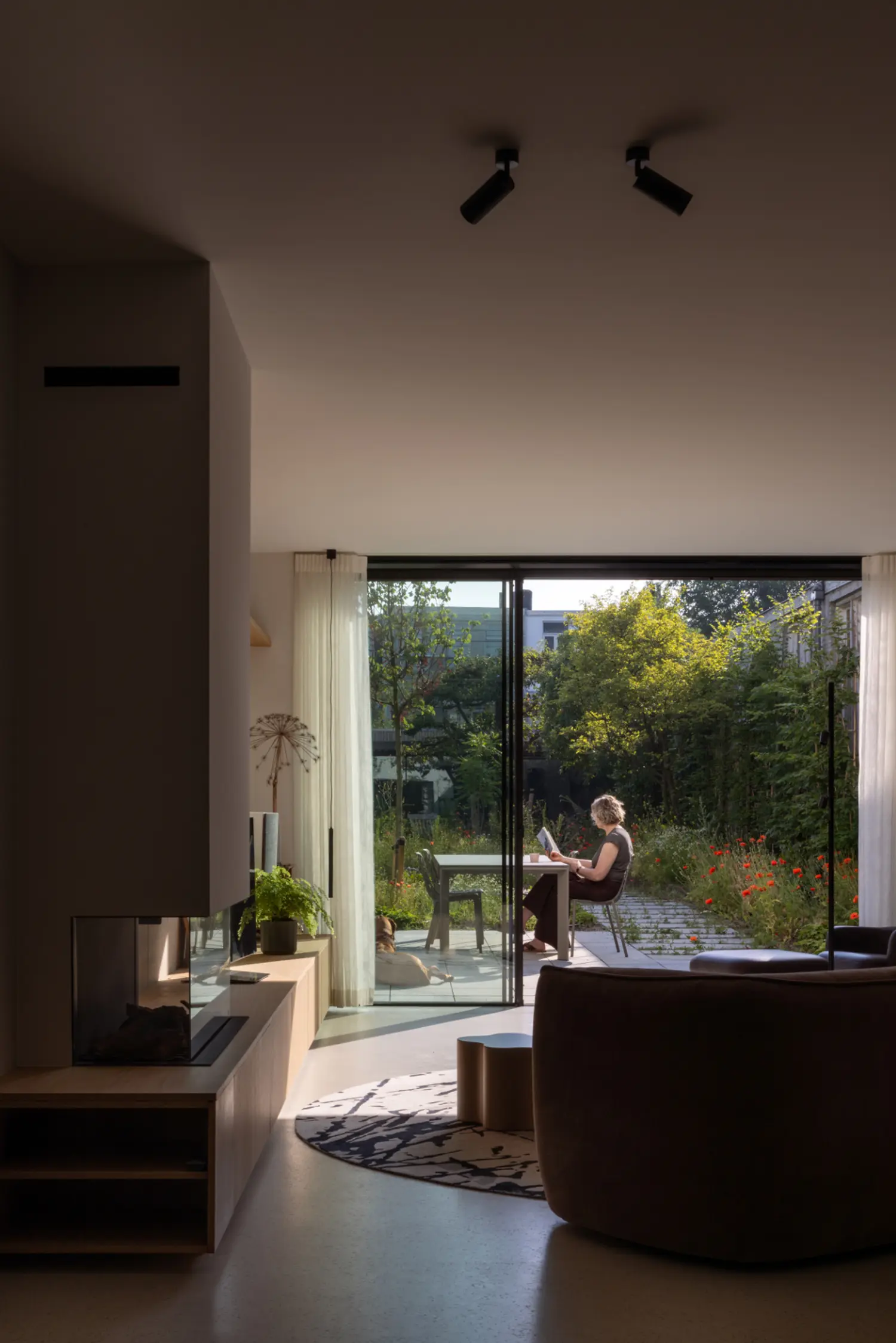 Living room of the renovated Rear House, DP6 architectuurstudio, Delft, with glazed wall framing the garden