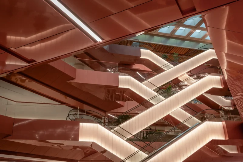 Central Park Bangkok by Linehouse, Copper Void escalators with backlit copper-toned cladding beneath a triangulated skylight