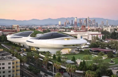 Lucas Museum of Narrative Art by MAD at dusk, aerial view over Exposition Park with green roof and solar panels; photo by Hufton+Crow