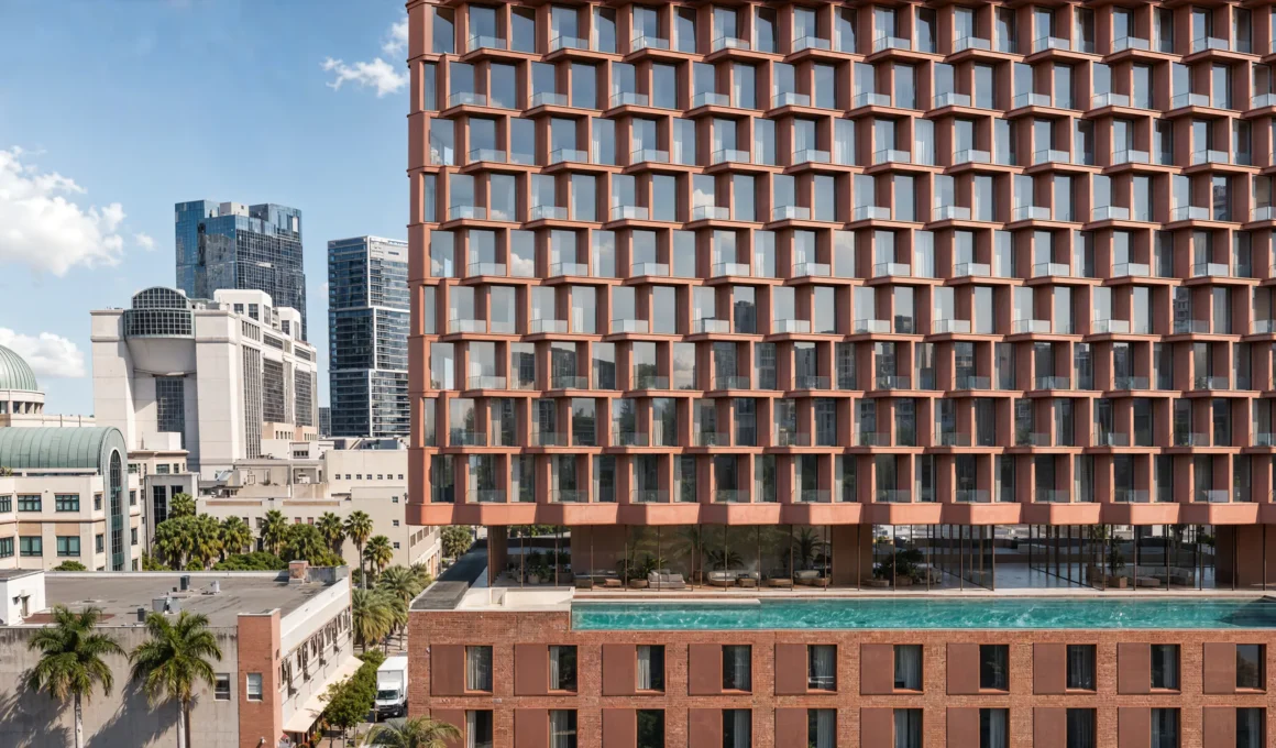 MiMar by CRA-Carlo Ratti Associati, terracotta zig-zag façade balconies above rooftop pool, West Palm Beach skyline