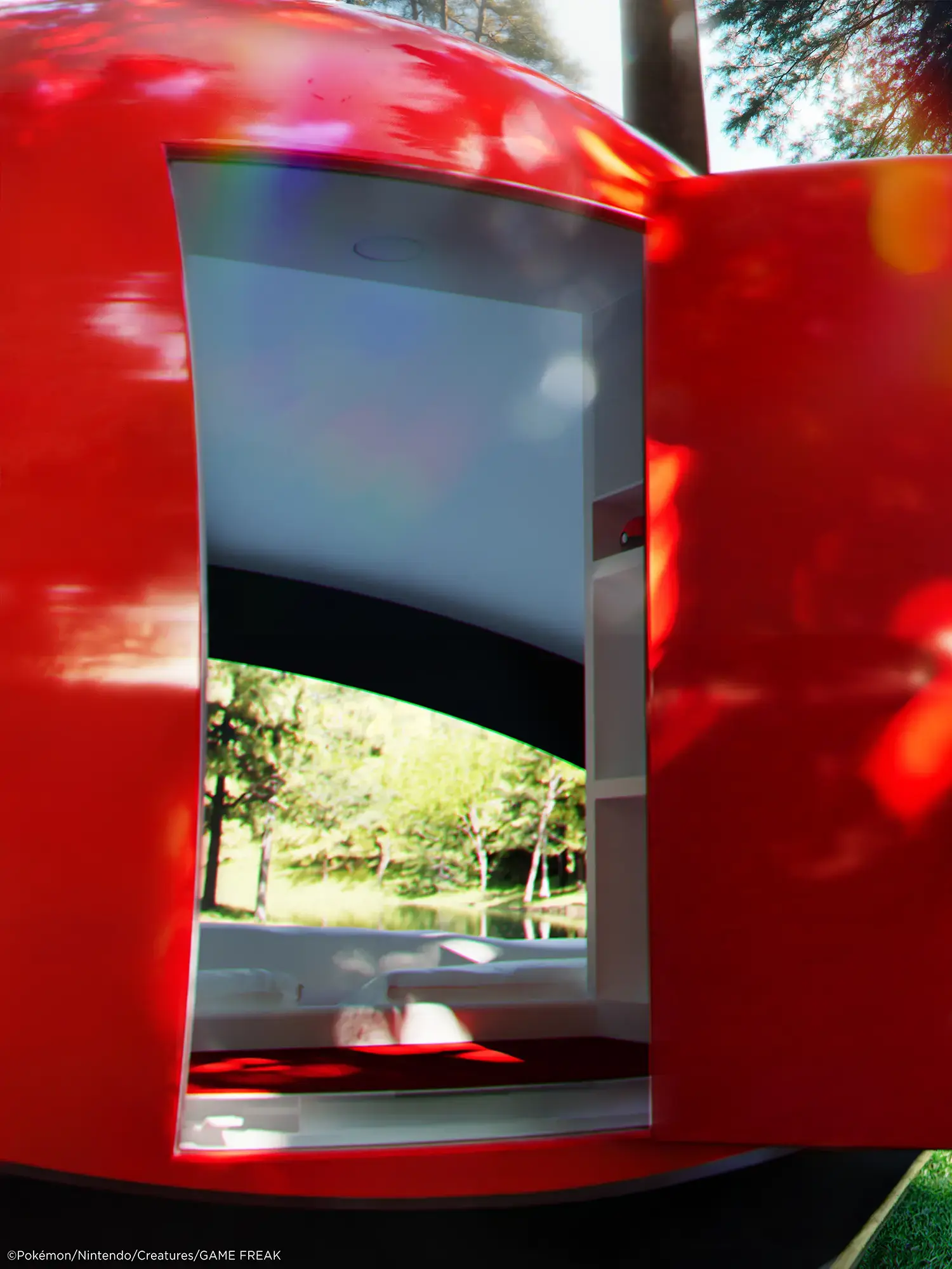 Open entrance door in the red upper shell of the Poké Ball-Themed Hotel by NOT A HOTEL ARCHITECTS, revealing the bed and window