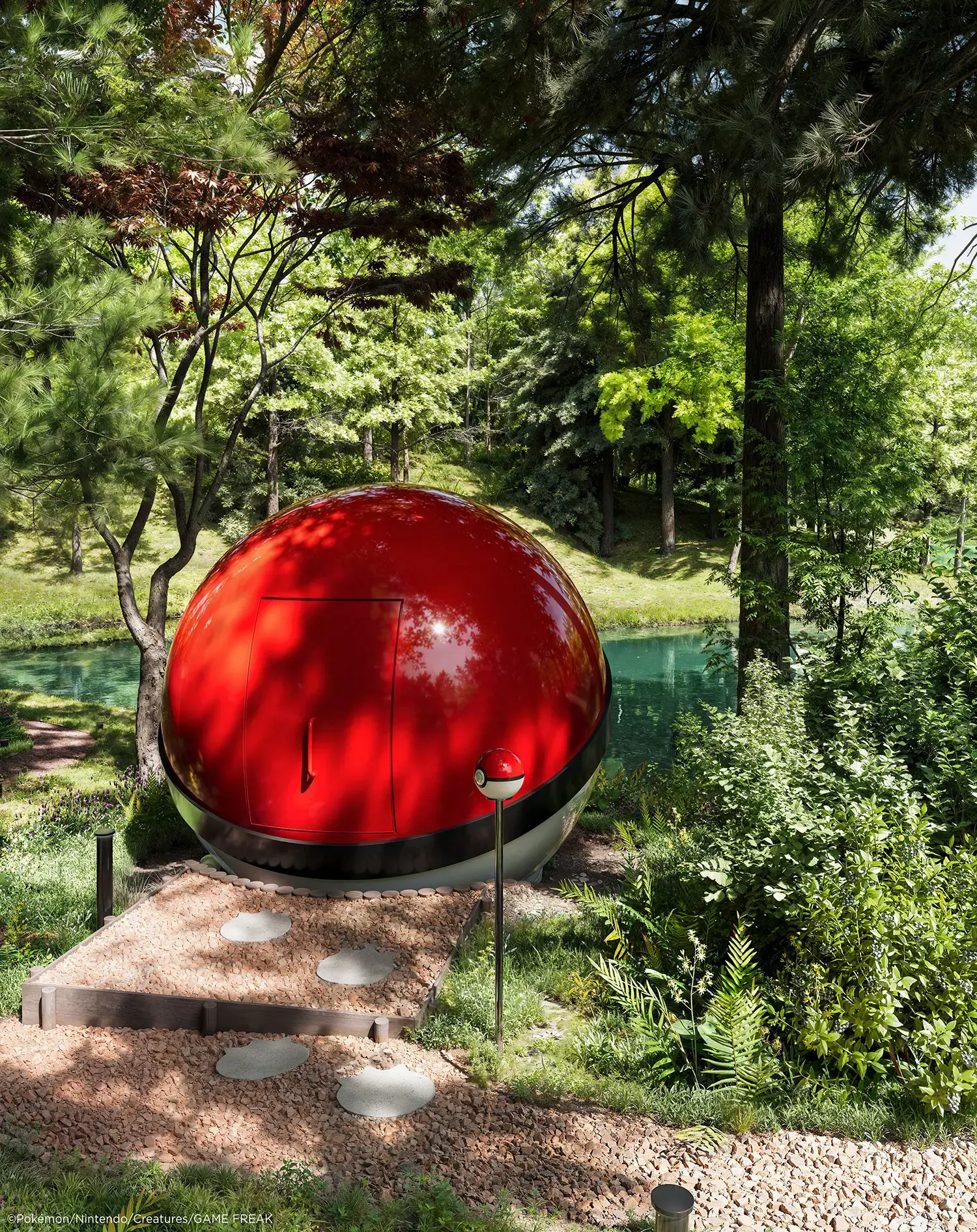Side of the Poké Ball-Themed Hotel by NOT A HOTEL ARCHITECTS, red shell with door, gravel path and stepping stones by a lake