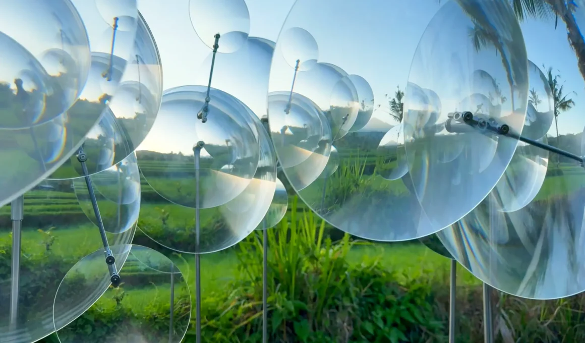 Eccentric Lenses by Vincent Leroy, overlapping circular Fresnel lenses on slim vertical supports above rice terraces in Munduk, Bali