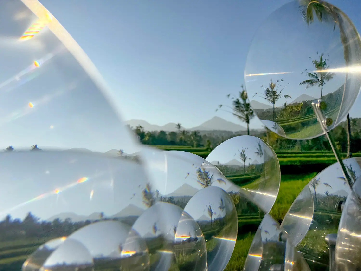 Eccentric Lenses by Vincent Leroy, rice terraces, palms and mountains seen through overlapping Fresnel lenses, Munduk, Bali